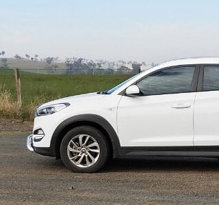Drive Less Pay Less . Couple and Car Image 